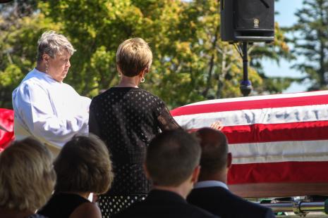 Rev Olson and Mary K. (Hubert) Hagen with her hand on her brother's casket,